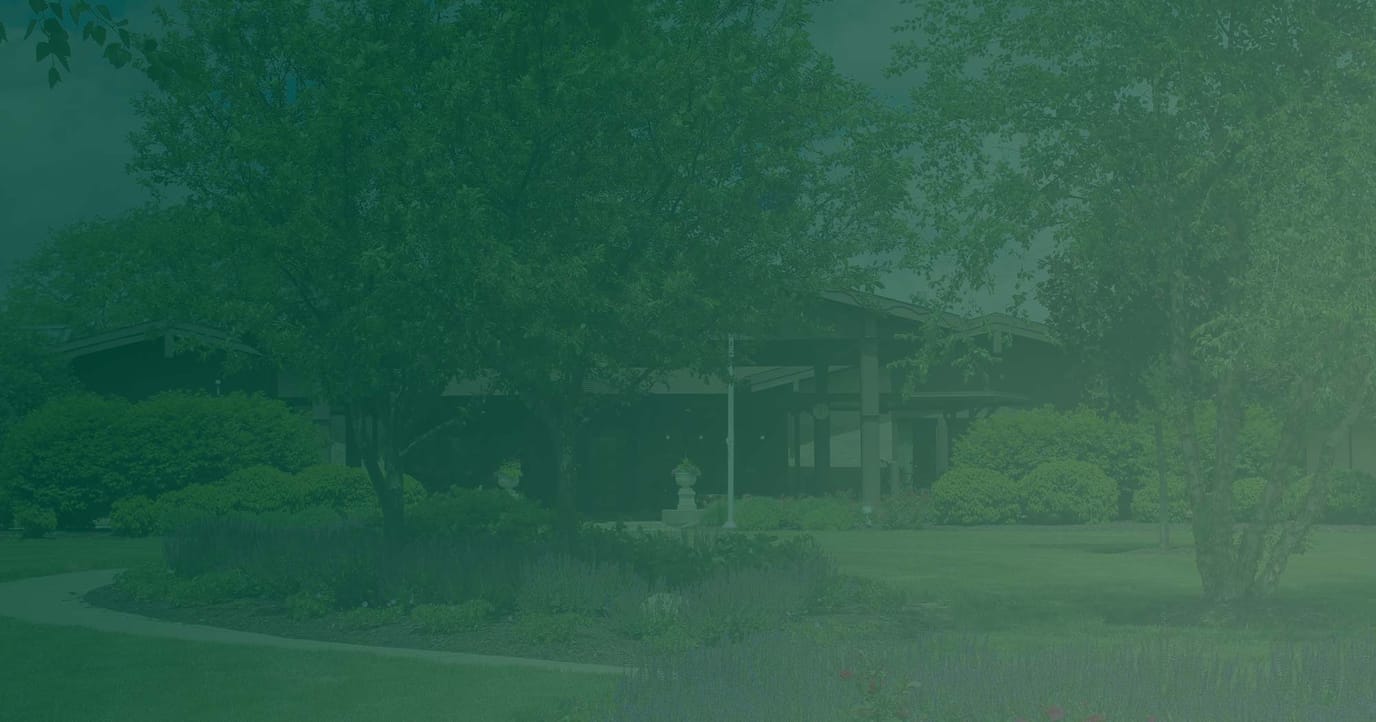 Well-maintained garden and building entrance at a senior facility