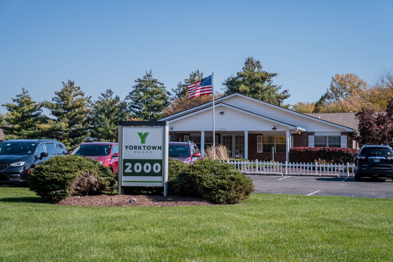 Exterior view of Yorktown Manor facility with greenery