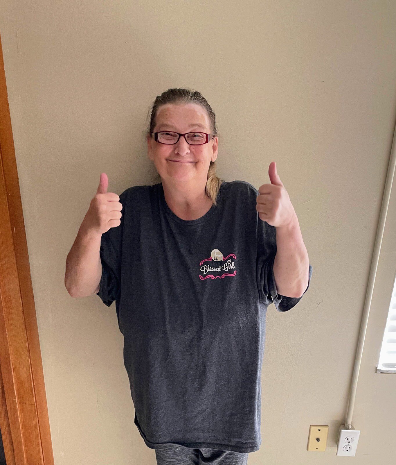 A resident giving thumbs up in a well-lit room