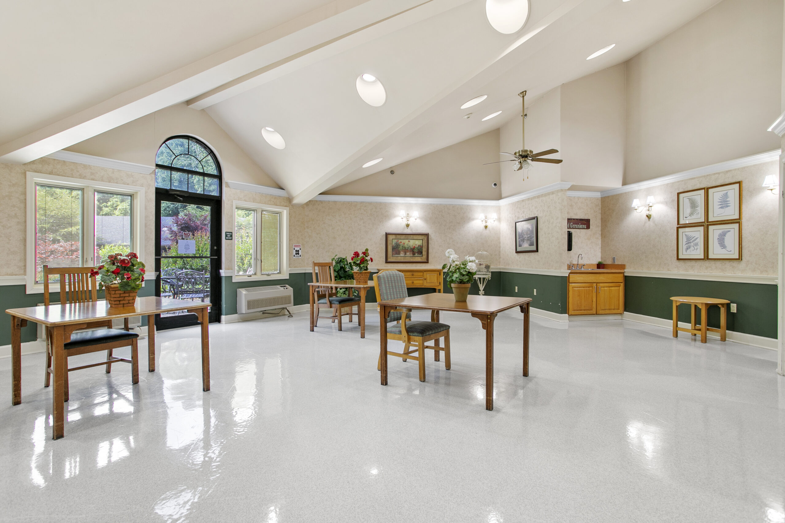 Bright activity room with tables and chairs