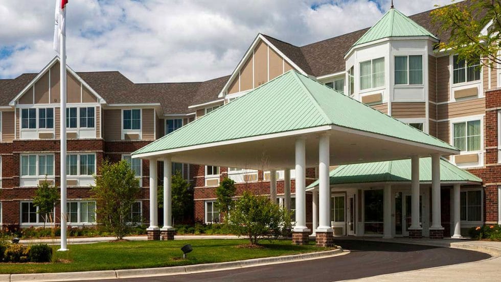 Front entrance of a senior living facility with a covered entry