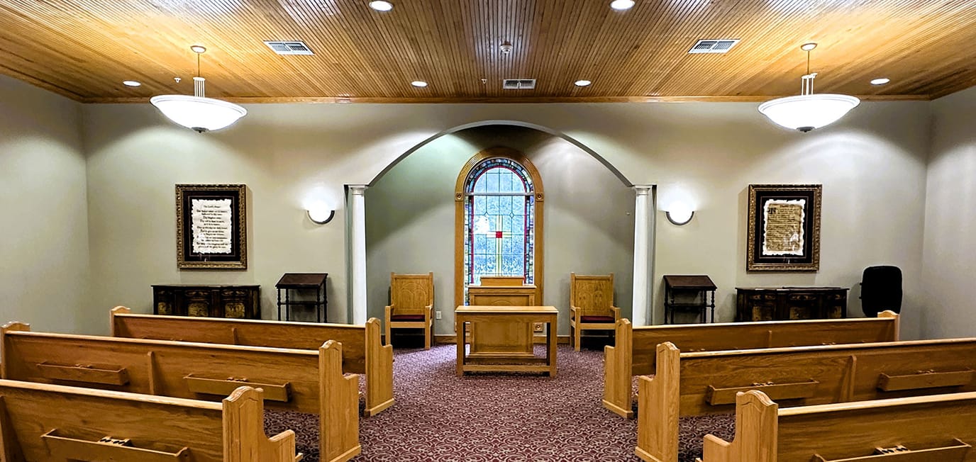 Interior view of a chapel with wooden seating
