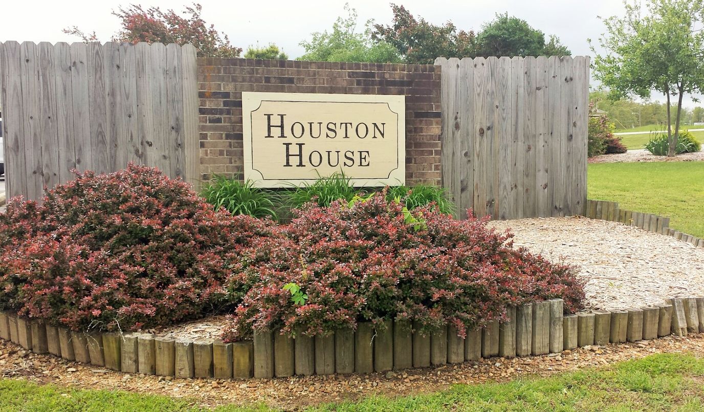 Signage for Houston House with landscaped area
