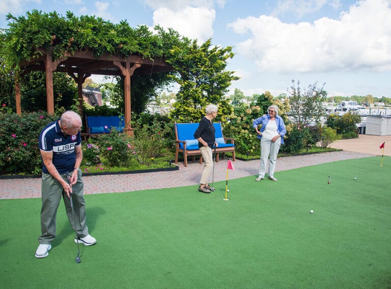 Residents enjoying a mini-golf activity in the garden