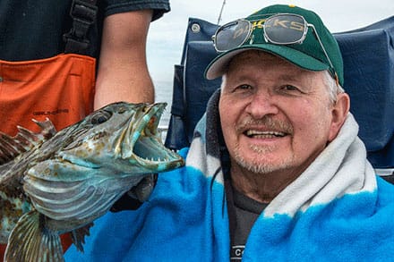 Marquis Forest Grove Post Acute Rehab, Nursing Home in Forest Grove, OR — Smiling fisherman holding a large fish outdoors