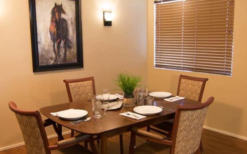 A dining table set with plates in a cozy interior