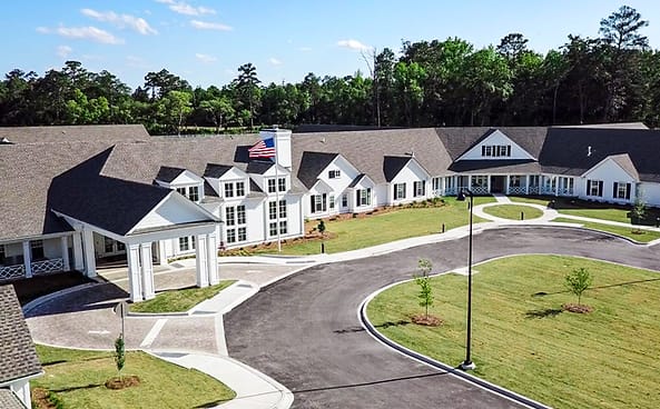 Aerial view of a senior living facility with landscaped grounds