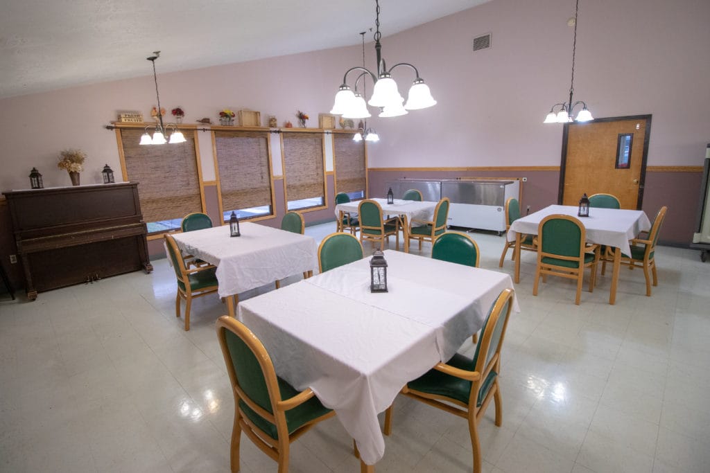 Dining area with tables and chairs set for meals