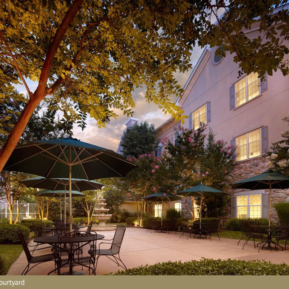 Beautiful courtyard with tables and umbrellas in the garden