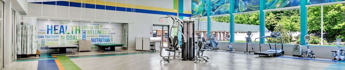 Well-lit fitness room with exercise equipment