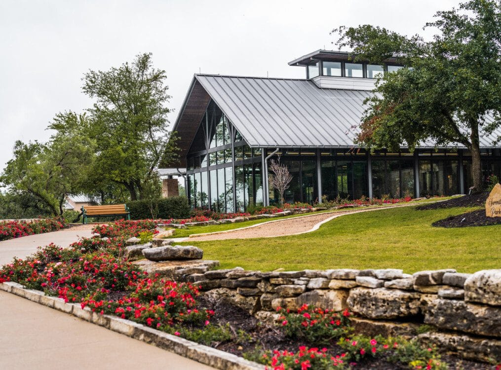 Exterior view of a modern assisted living facility surrounded by flowers