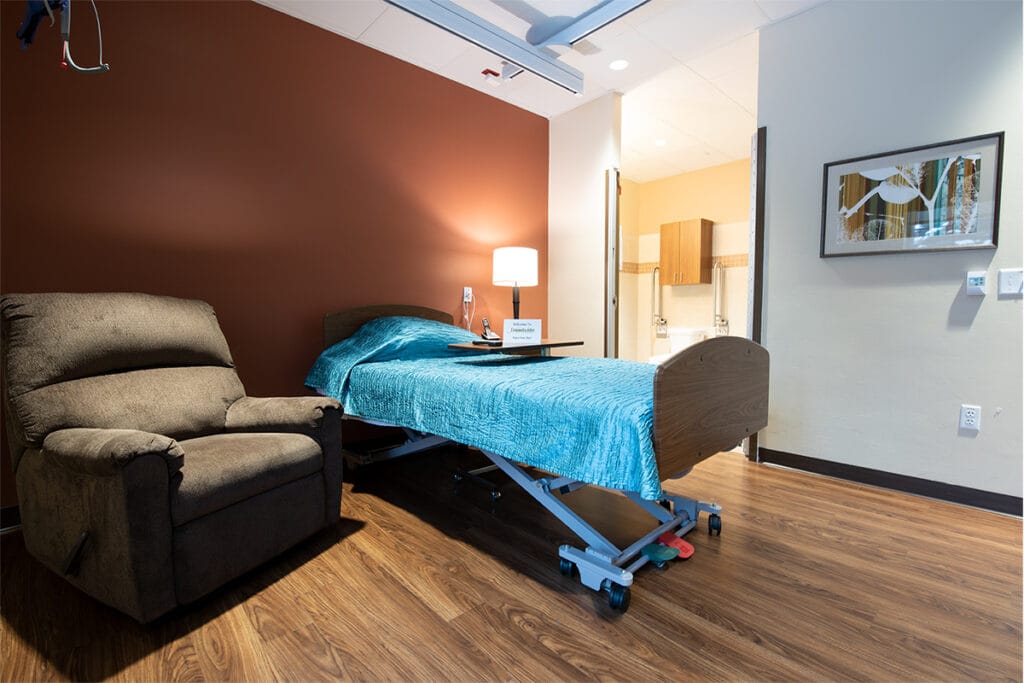 Cozy resident room with a bed and recliner