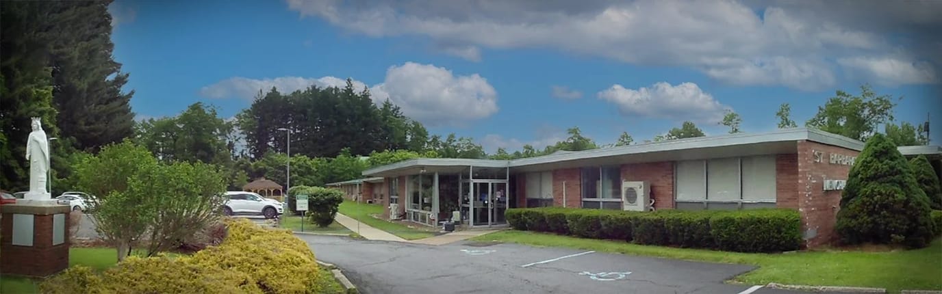 Exterior view of a senior living facility with gardens