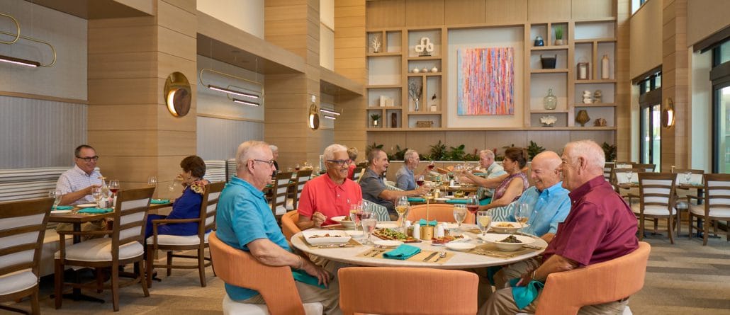 Residents enjoying a meal in a spacious dining room