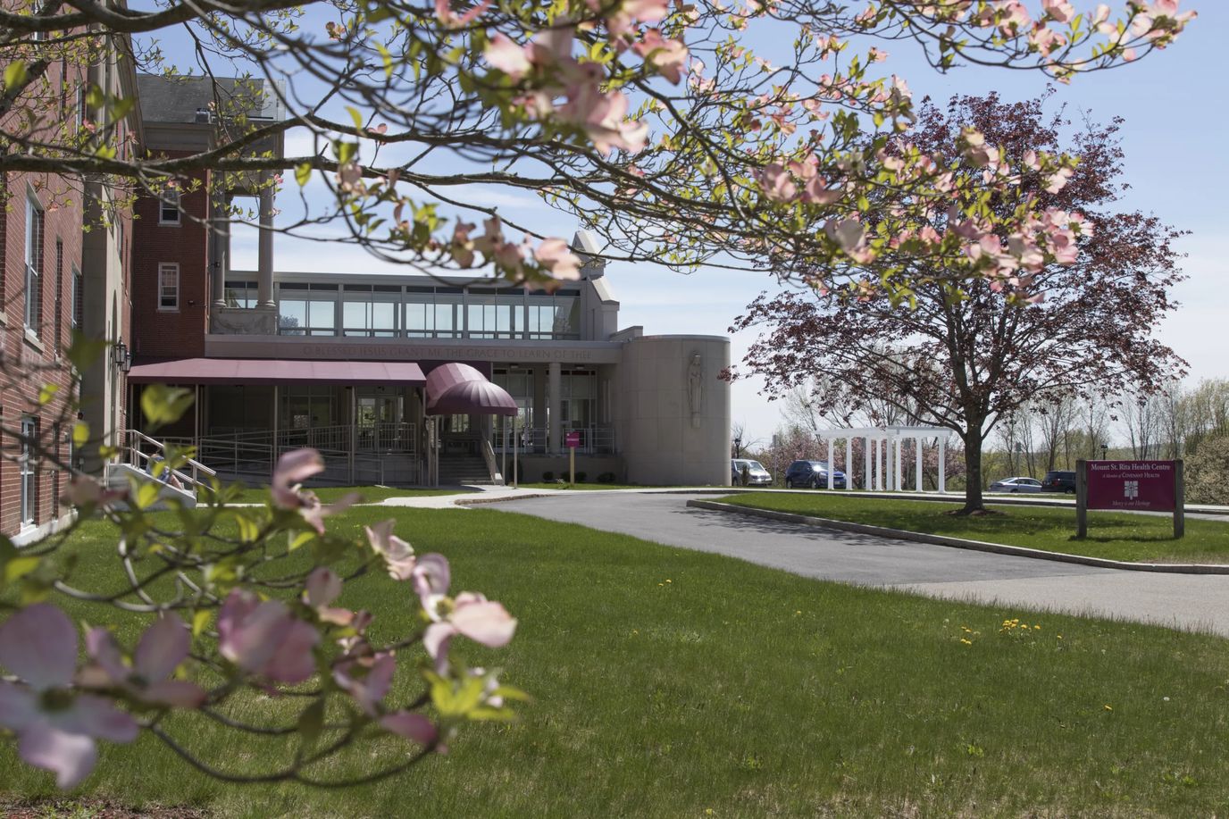 Exterior view of a senior living facility with flowering trees