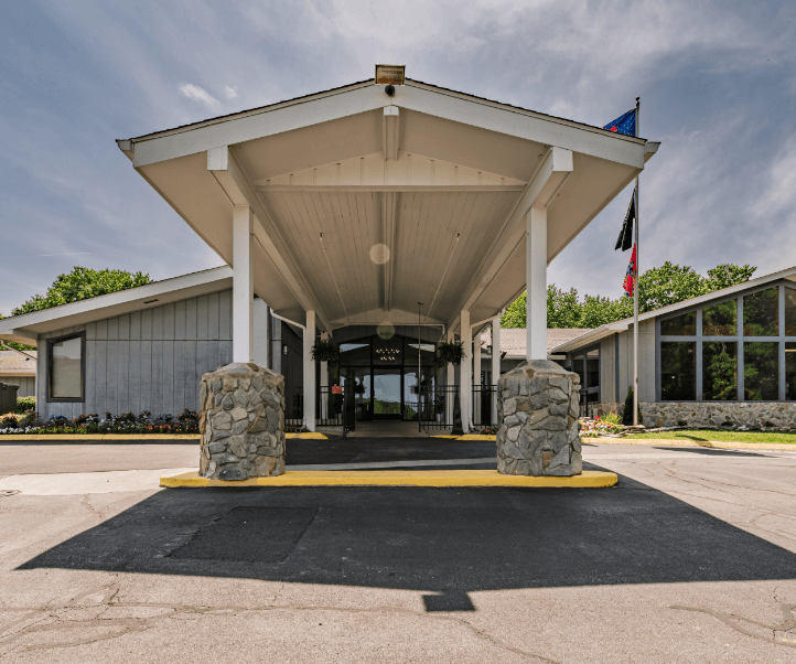 Front entrance of a senior living facility with a covered porch