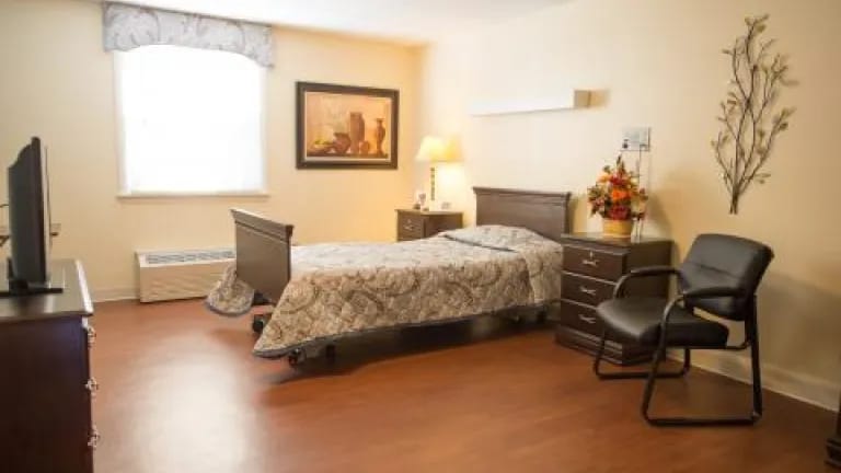 Cozy private resident room with bed and furniture
