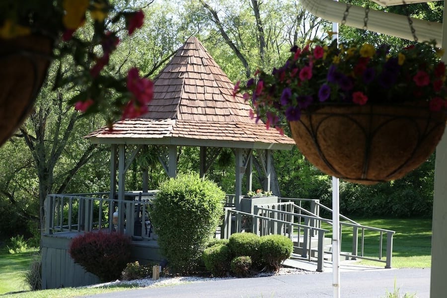 Outdoor gazebo surrounded by flowers in a garden