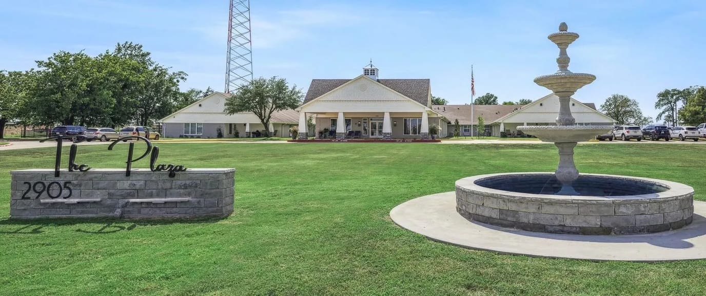 Exterior view of The Plaza with fountain and lawn