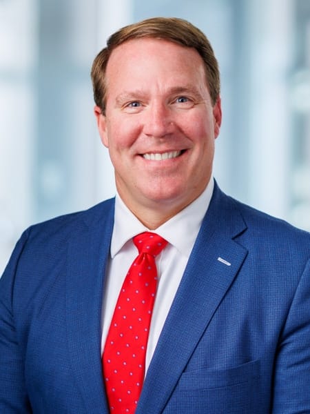 Professional portrait of a smiling man in a suit
