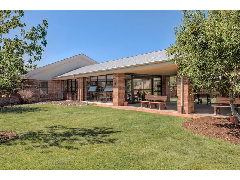 Outdoor patio area with seating and grass