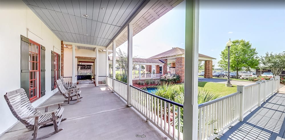 Covered walkway with outdoor seating at Camelot Brookside