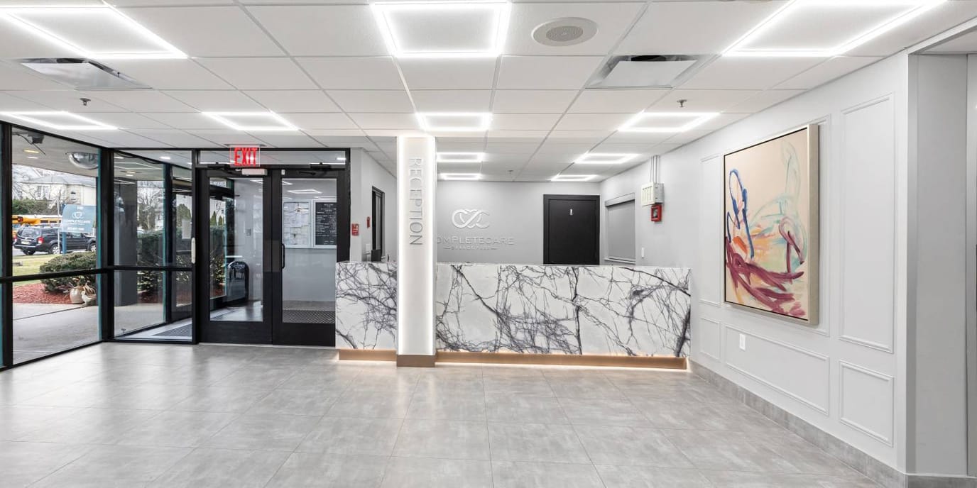 Complete Care At Orange Park, Nursing Home in East Orange, NJ — Modern reception area with marble counter and artwork