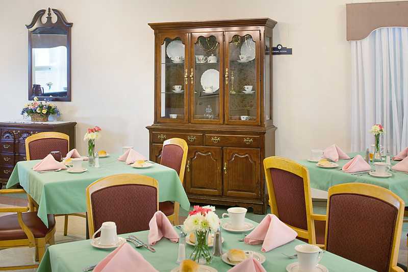Dining area set with tables and floral centerpieces