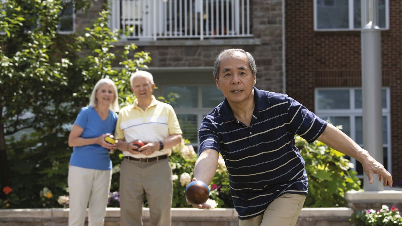 Residents enjoying a game of bocce ball outdoors