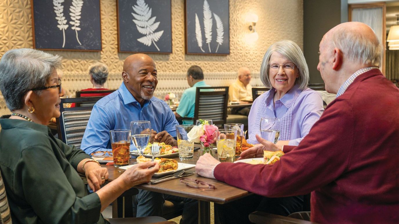 Residents enjoying a meal together in a dining area