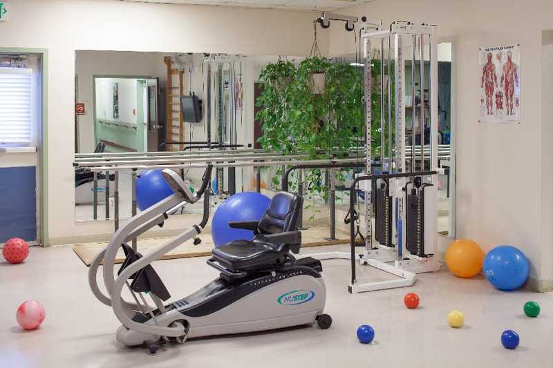 Casa De Oro Center, Nursing Home in Las Cruces, NM — Exercise equipment in a well-lit rehabilitation room
