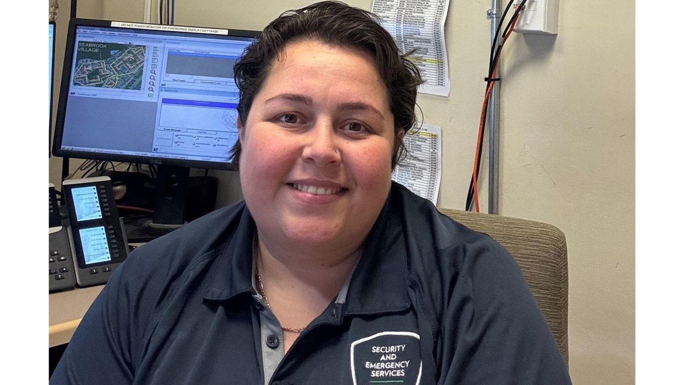 Staff member at a security desk in the facility