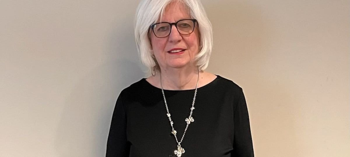 Continuing Care At Seabrook, Nursing Home in Tinton Falls, NJ — Woman with white hair wearing a black top and necklace