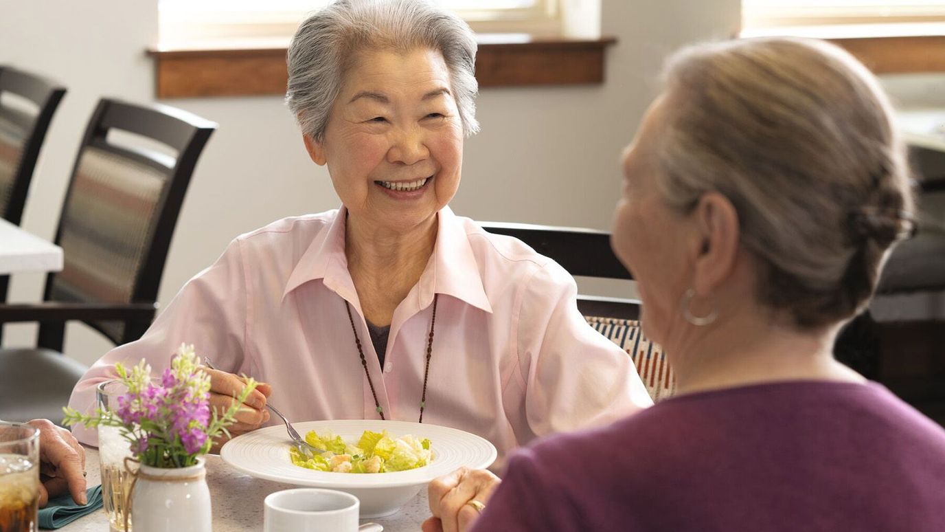 Residents enjoying a meal together in a dining room