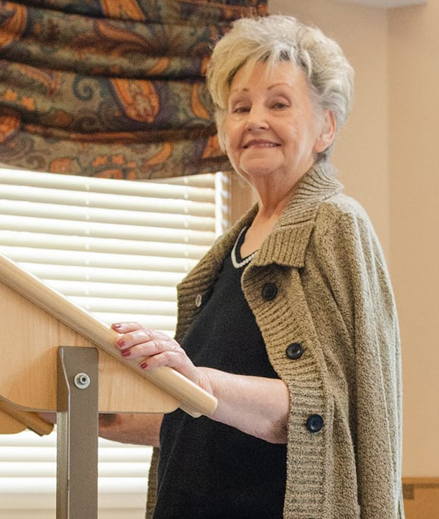 Smiling resident at a podium in a common area