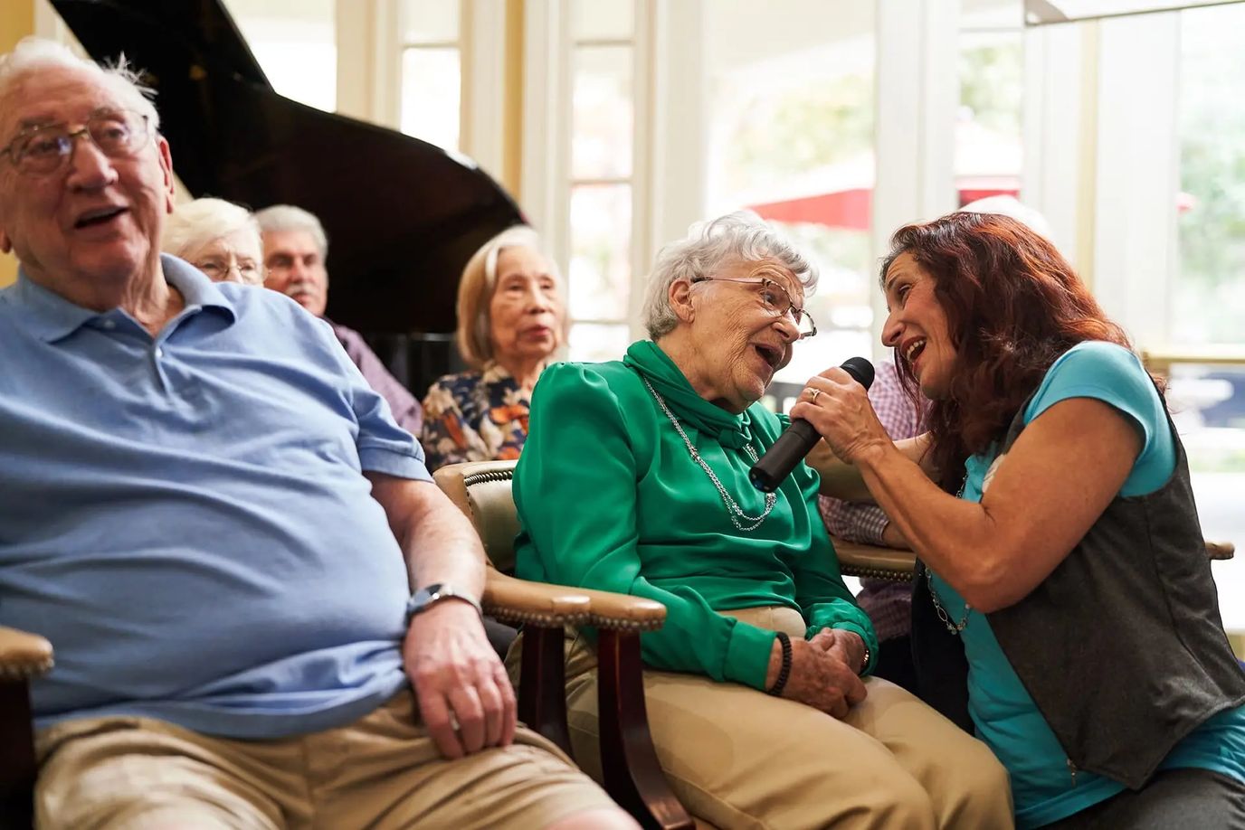 Residents enjoying a musical performance in a common area