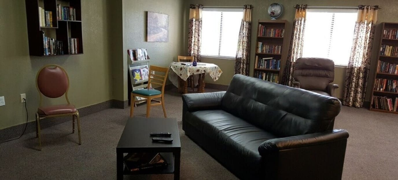 Cozy common area with seating and bookshelves