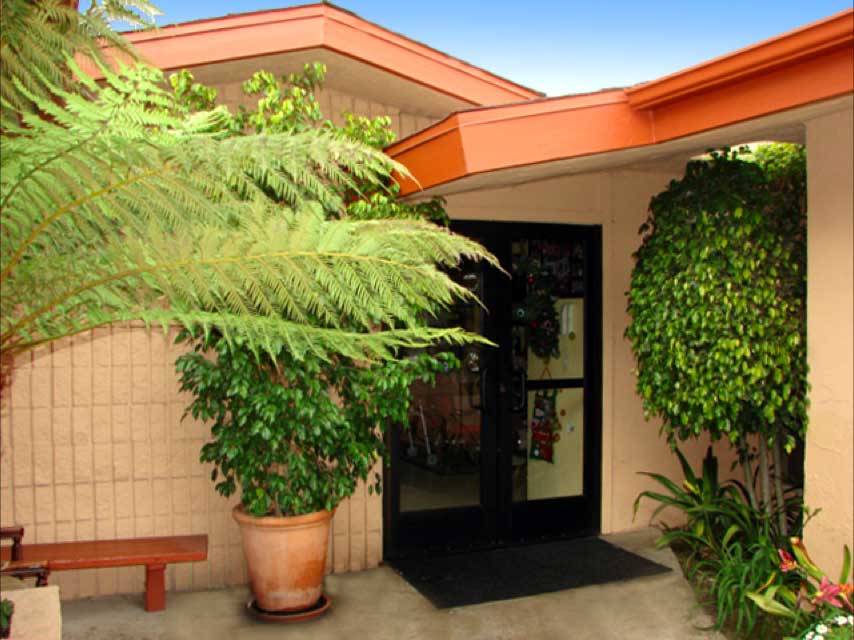 Entrance to a facility with greenery and welcoming features