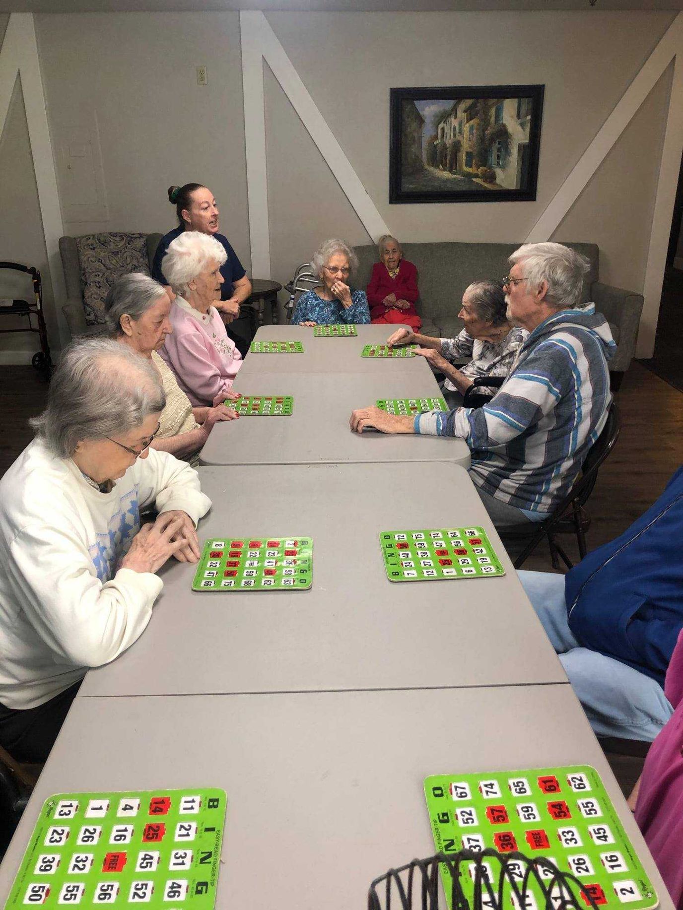 Residents engaged in a bingo game in an activity room