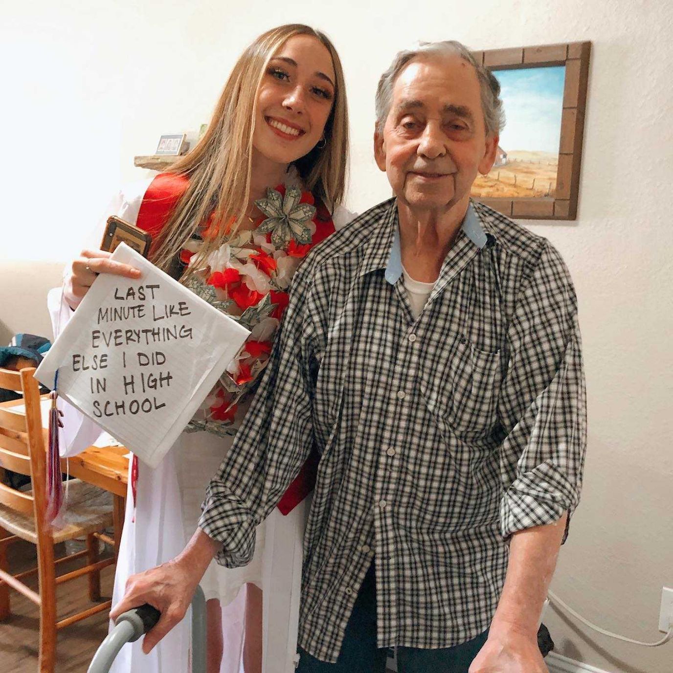 Resident and staff member posing together with a sign