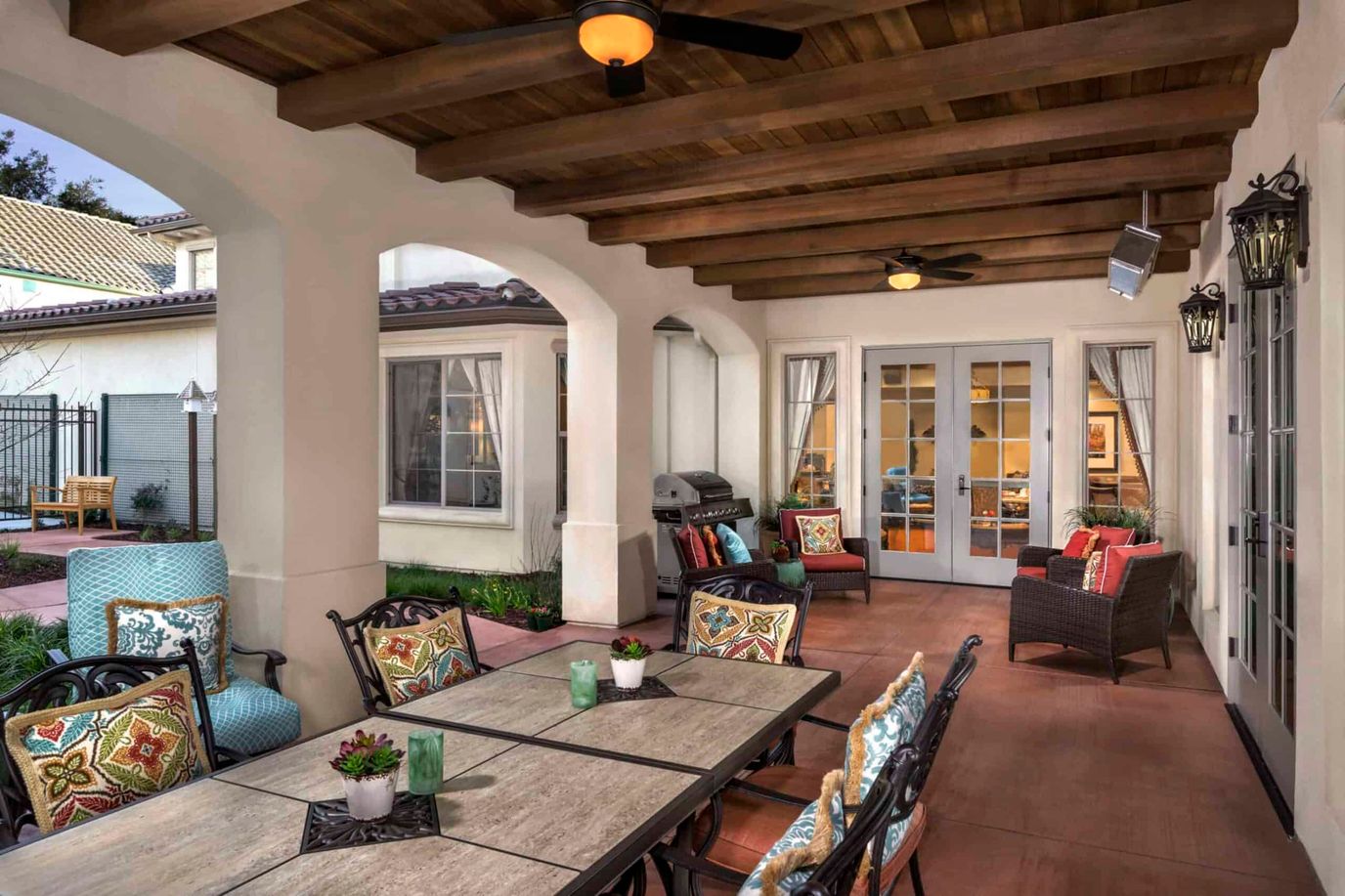 Outdoor seating area with chairs and tables under a pergola