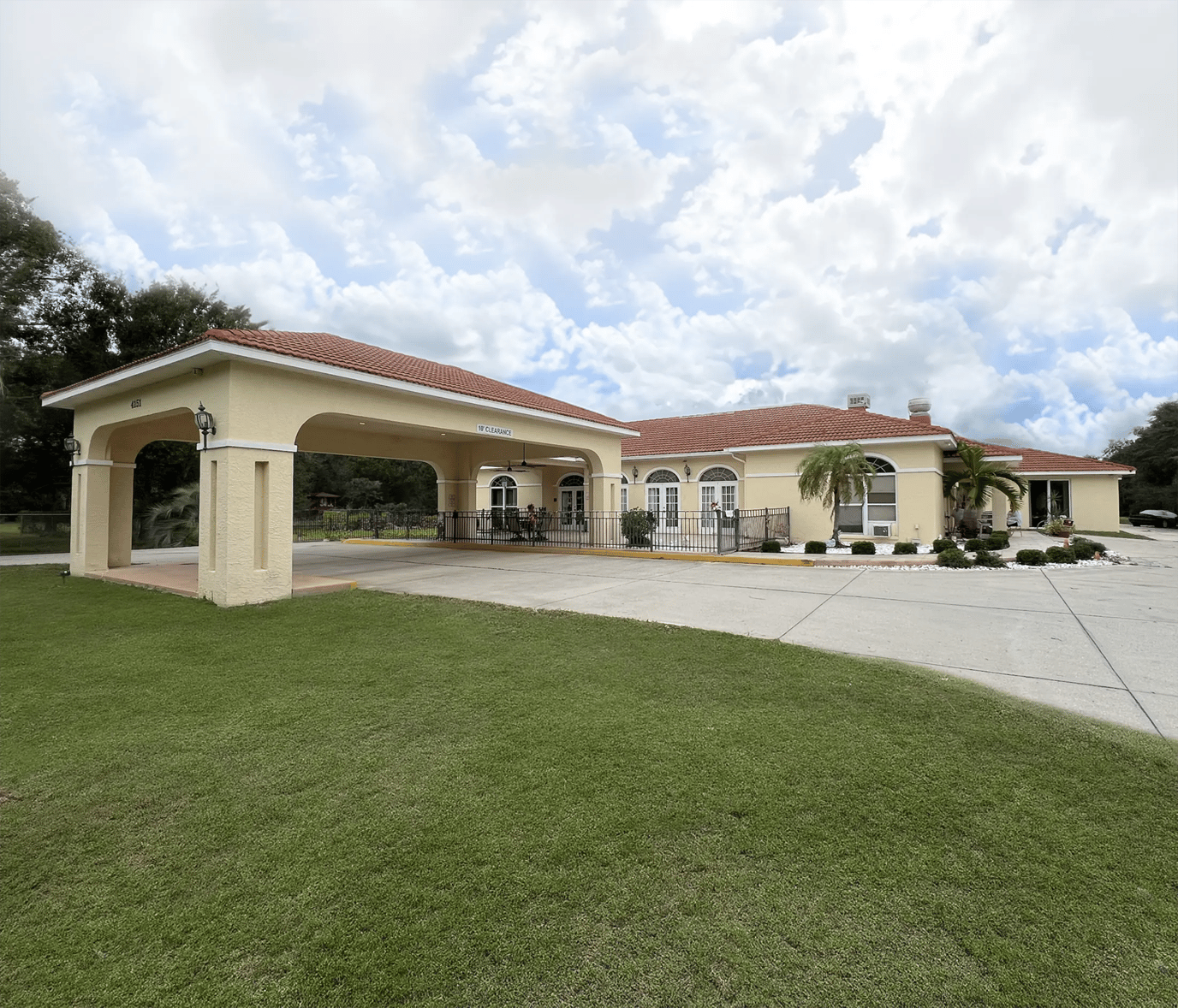 Exterior view of assisted living facility with landscaped entrance
