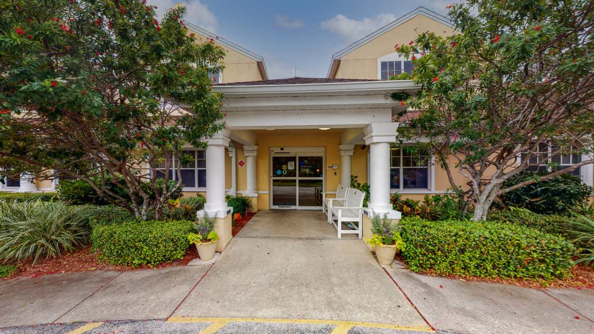 Front entrance of Aventura Bay Place with landscaped garden