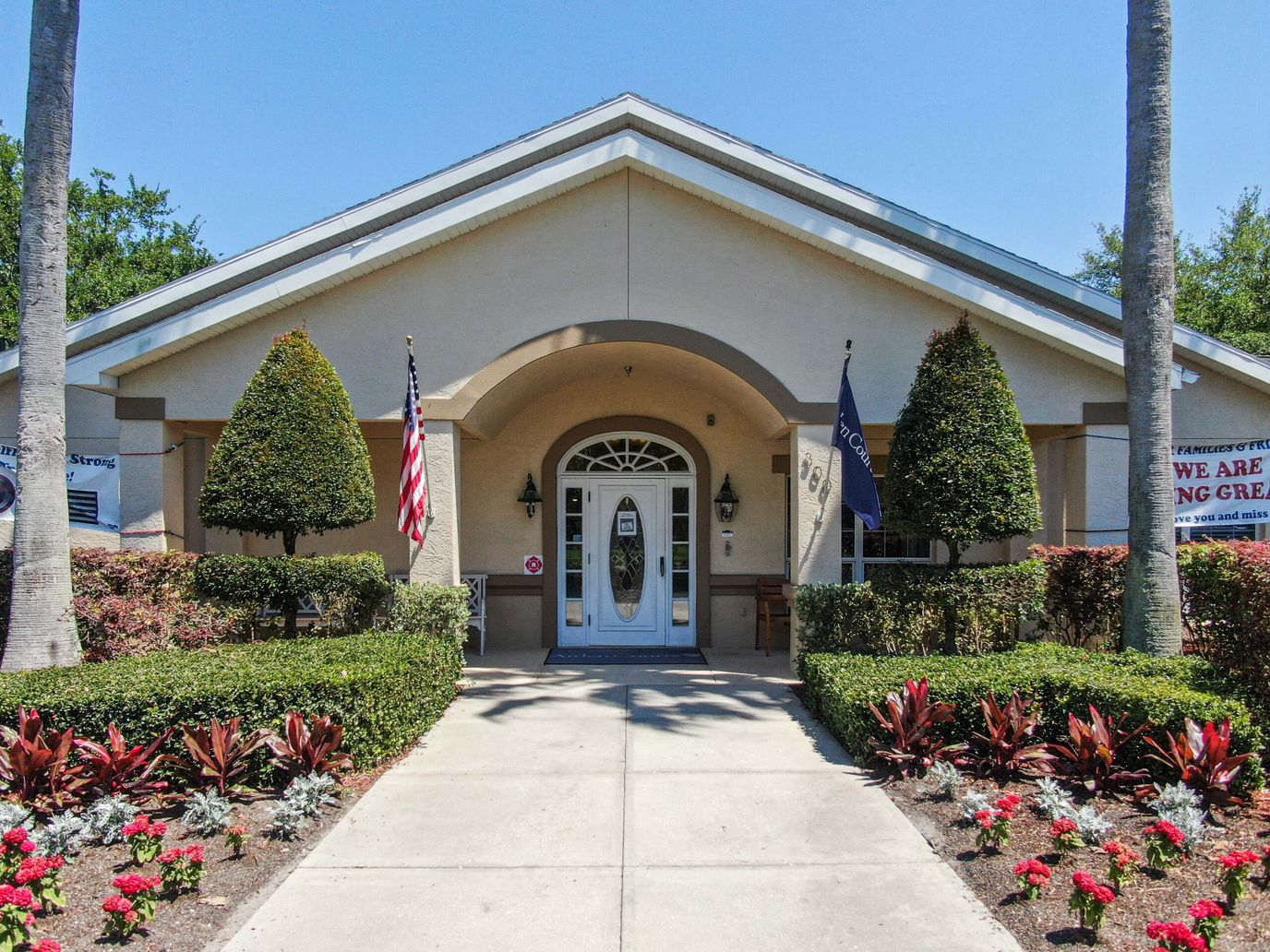 Front exterior of a senior care facility with landscaped entrance