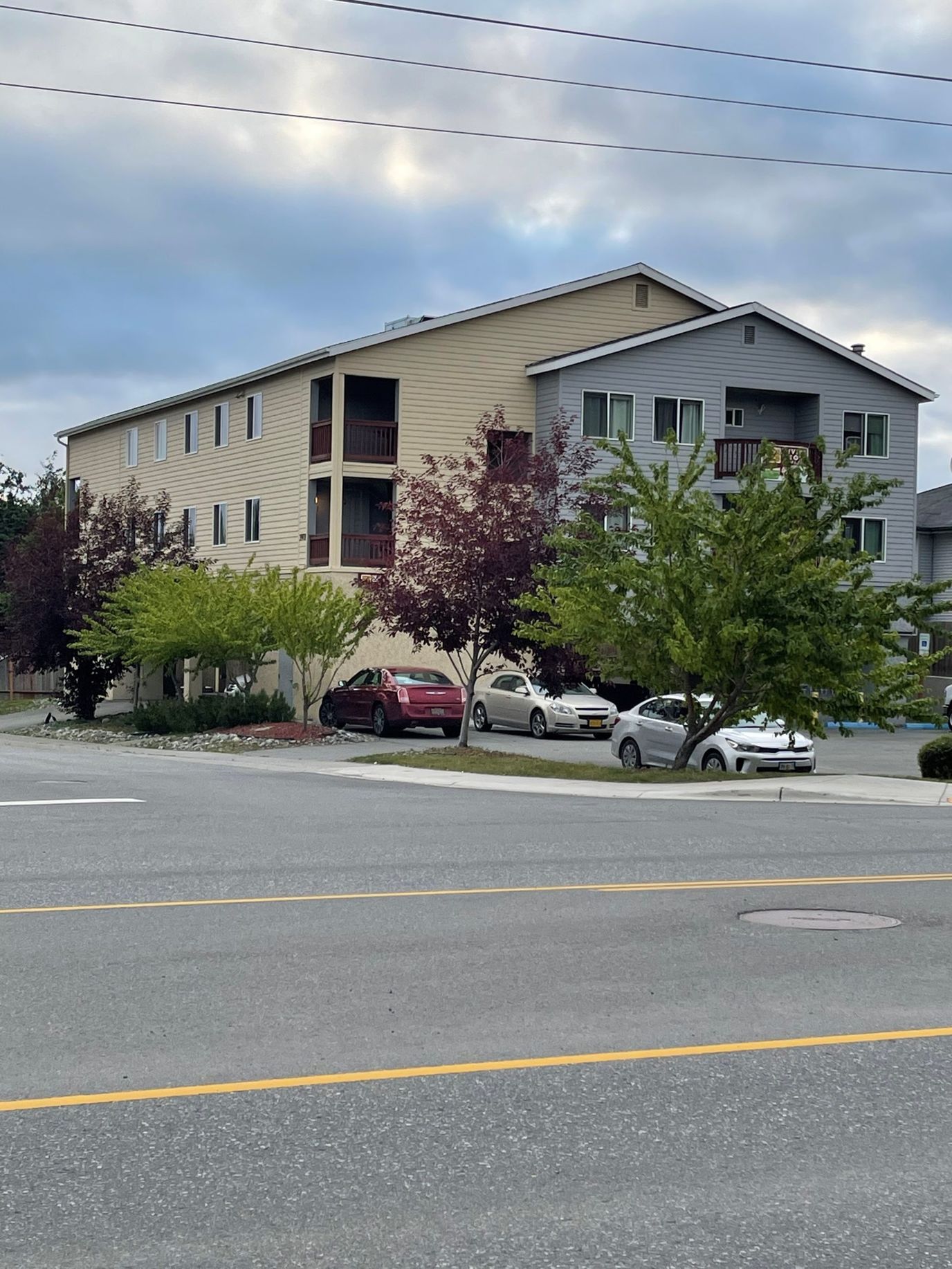 Exterior view of a senior living facility with surrounding trees
