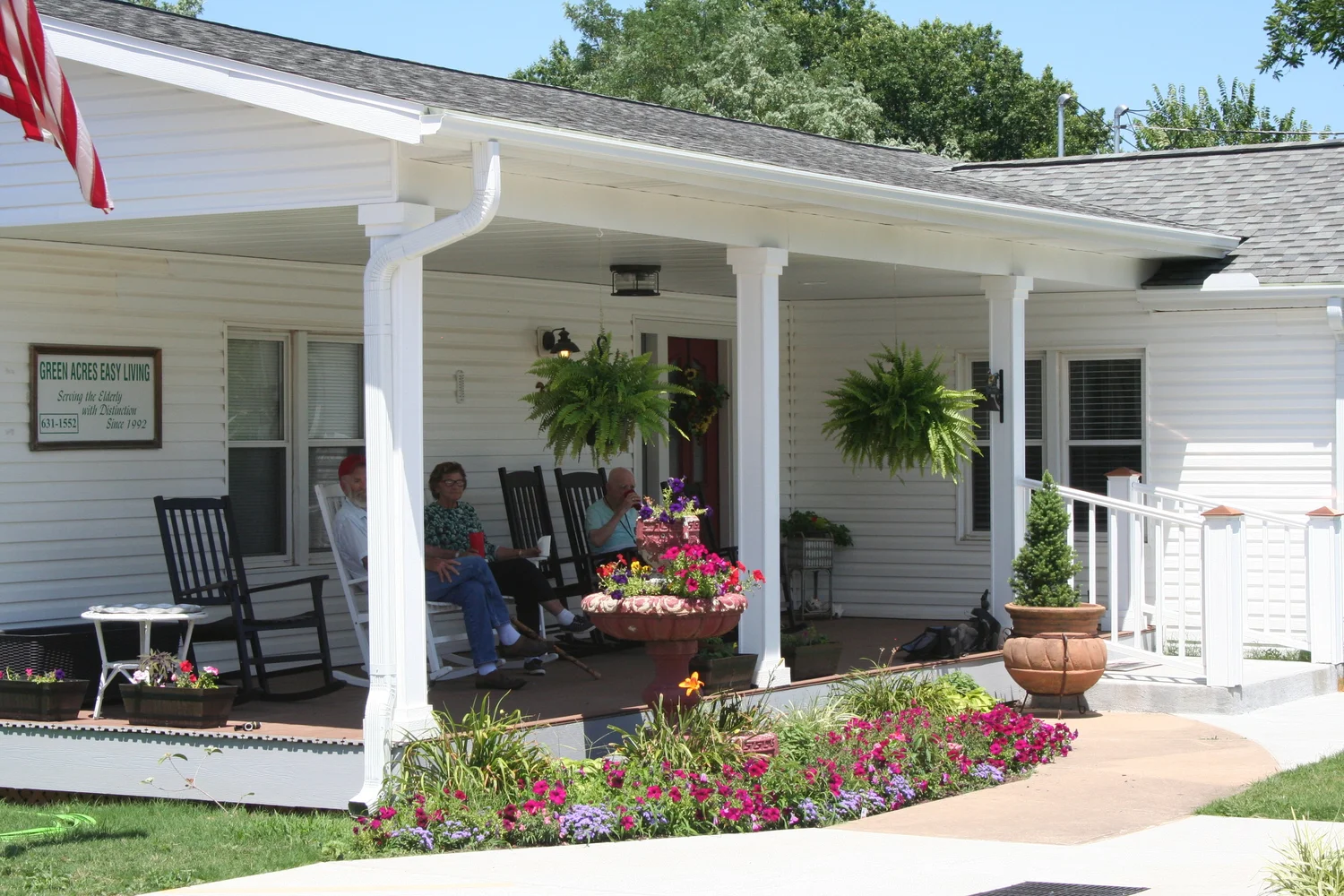 Residents enjoying the porch area with flowers