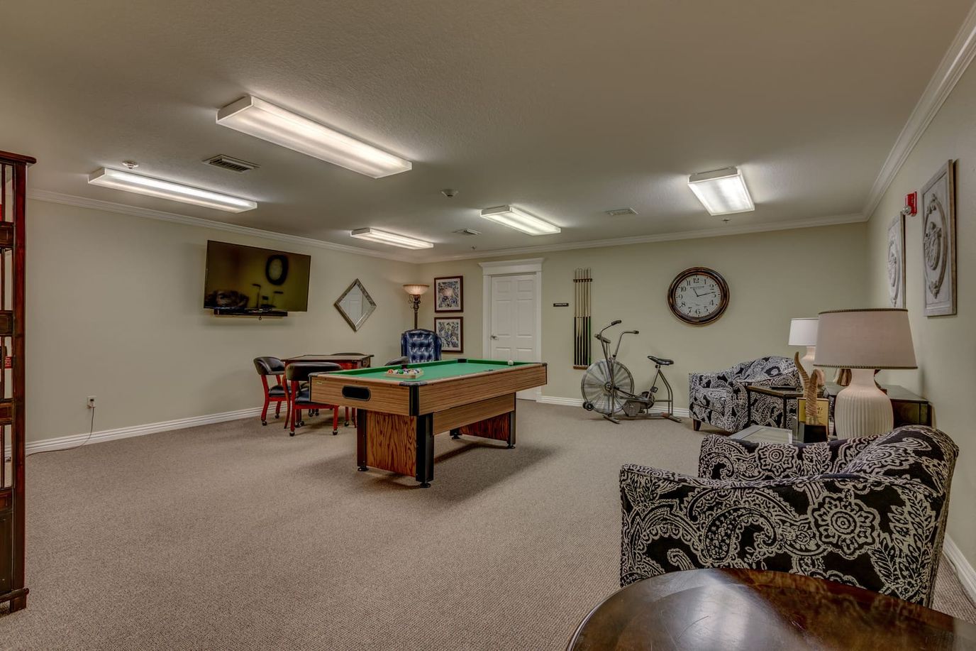 Game room with a pool table and seating area