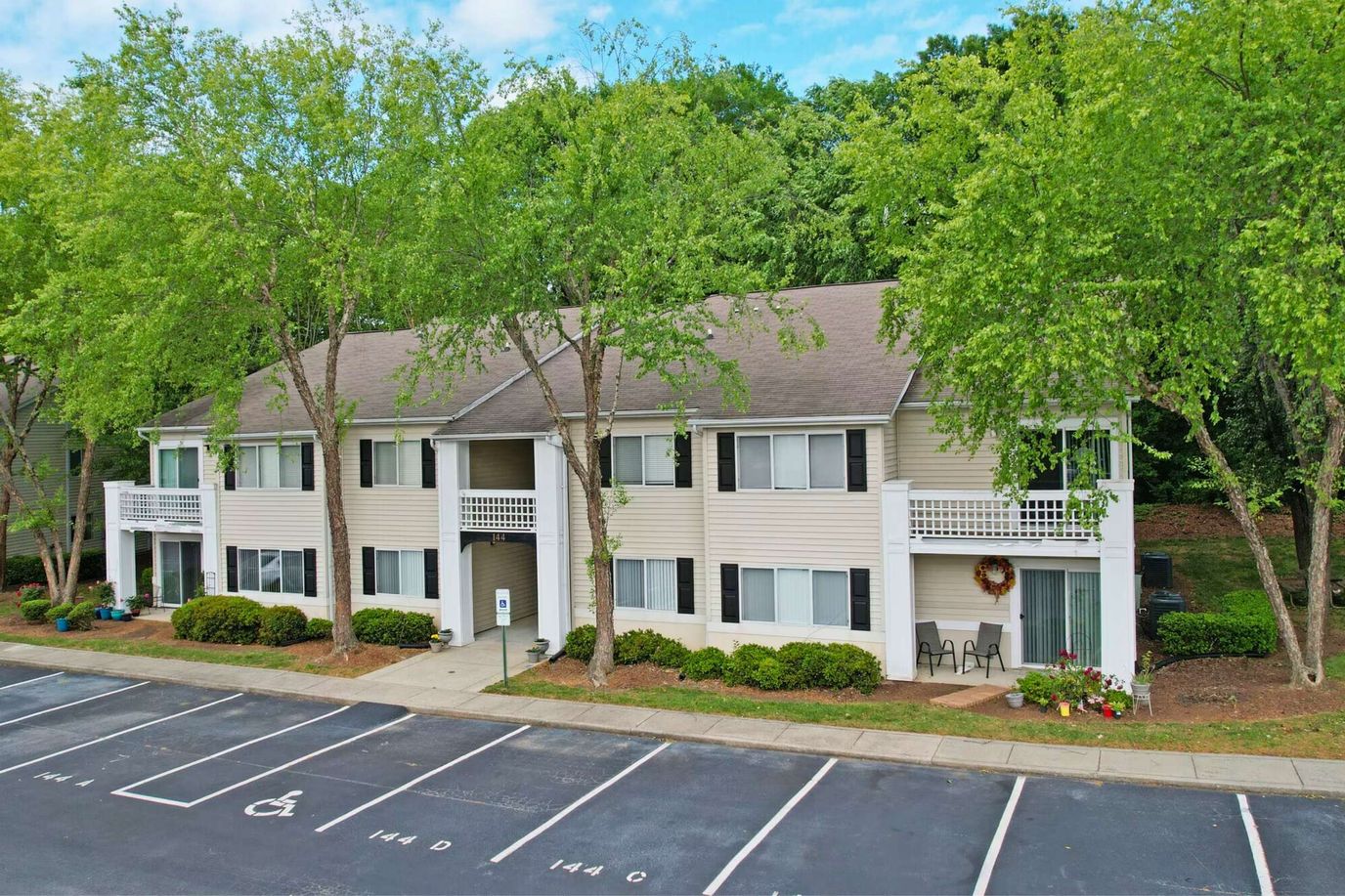 Exterior view of the Crescent Oaks building with green landscaping