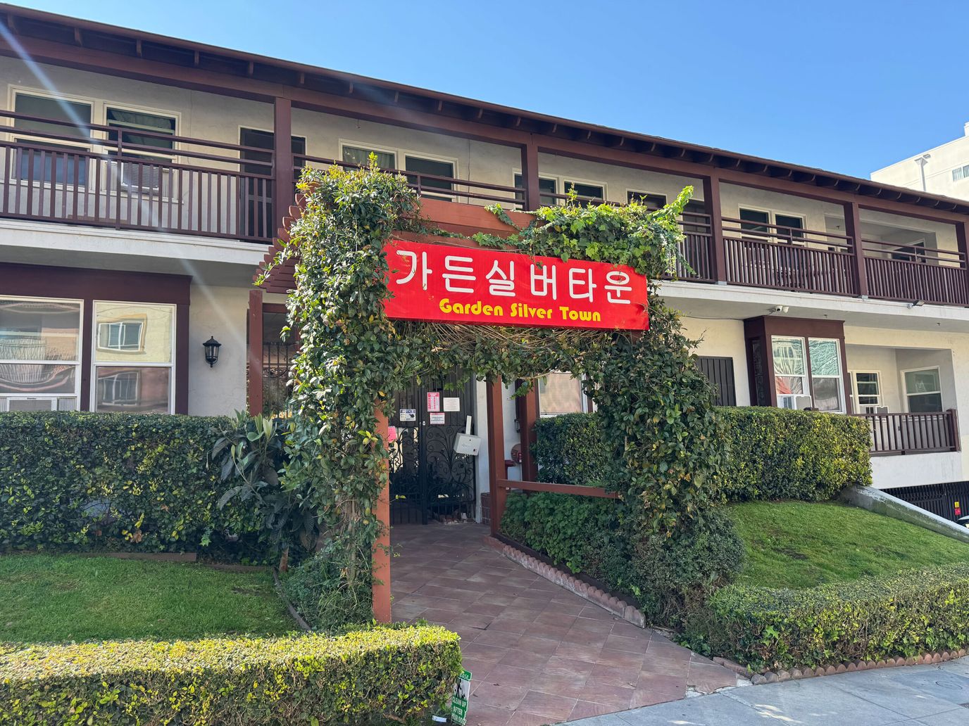 Entrance of Garden Silver Town with signage and greenery