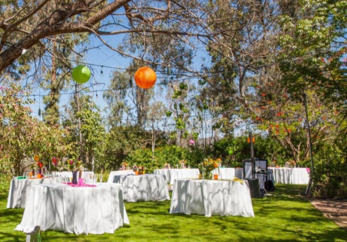 Outdoor event setup with tables and decorations